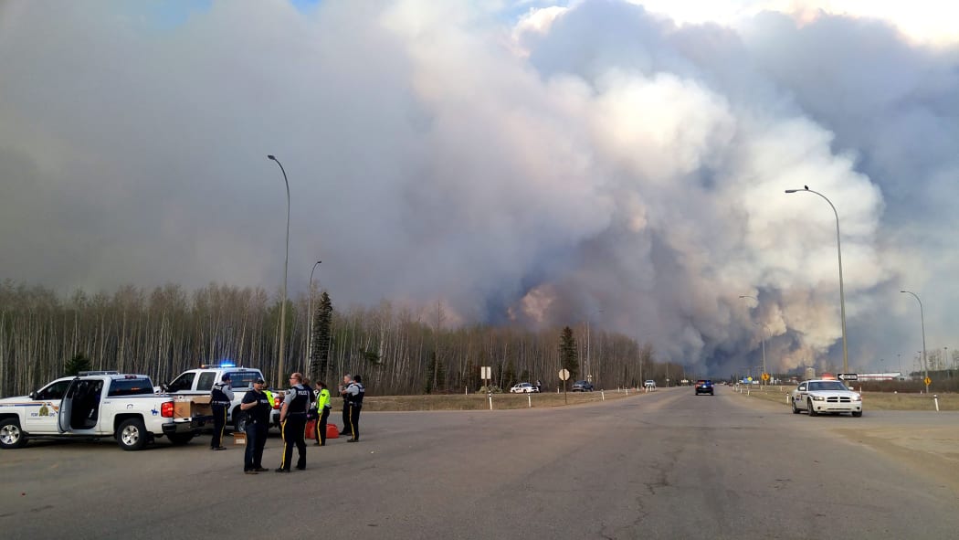 Members of the Royal Canadian Mounted Police monitor the Fort McMurray Wildfire.