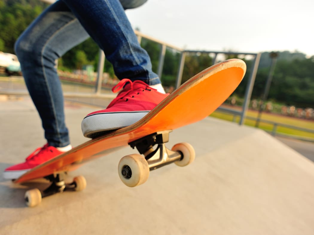 A person skateboarding at a skate park.