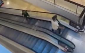 A man with a bollard faces off against a man armed with a knife at Bondi Westfield in Sydney.