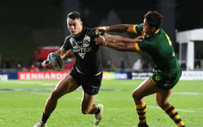 Young Kiwis star Joseph Manu puts a fend on Kangaroos opposite and Roosters team-mate Latrell Mitchell.
