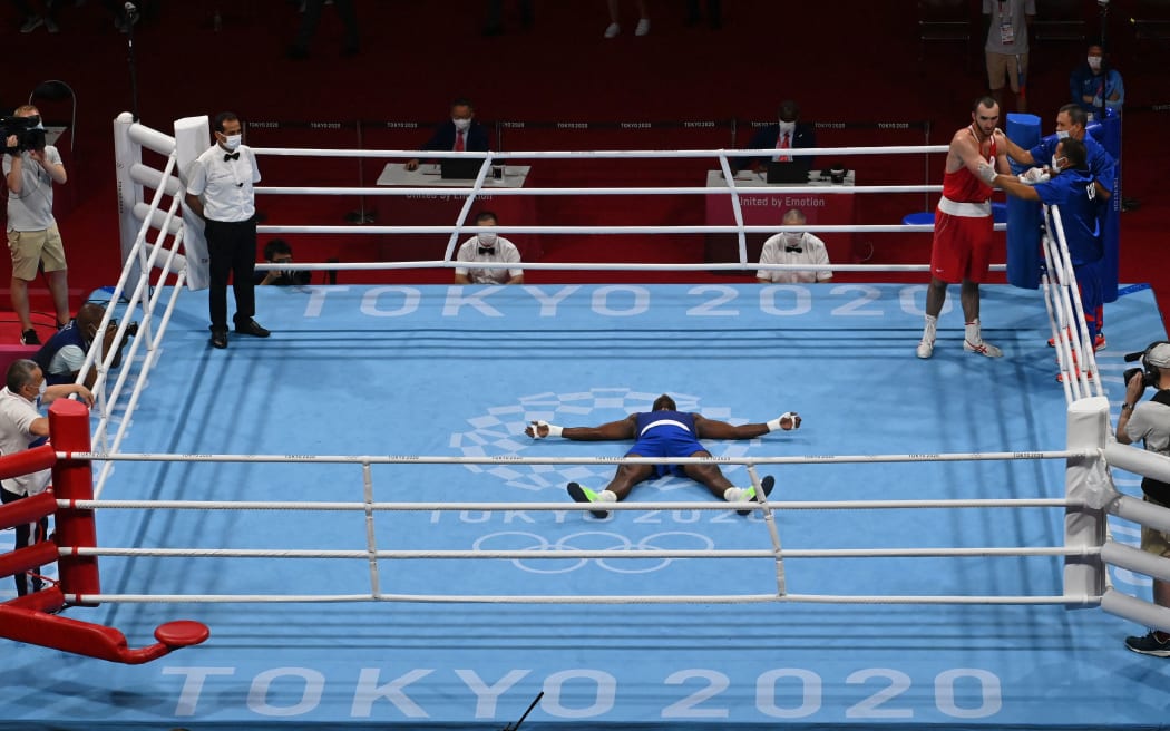 Cuba's Julio La Cruz celebrates after winning against  Russia's Muslim Gadzhimagomedov men's heavyweight boxing Tokyo Olympics.