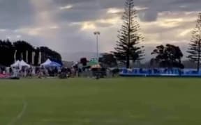 A still from video of the bouncy castle as it blew away during a New Year's festival in Tauranga.