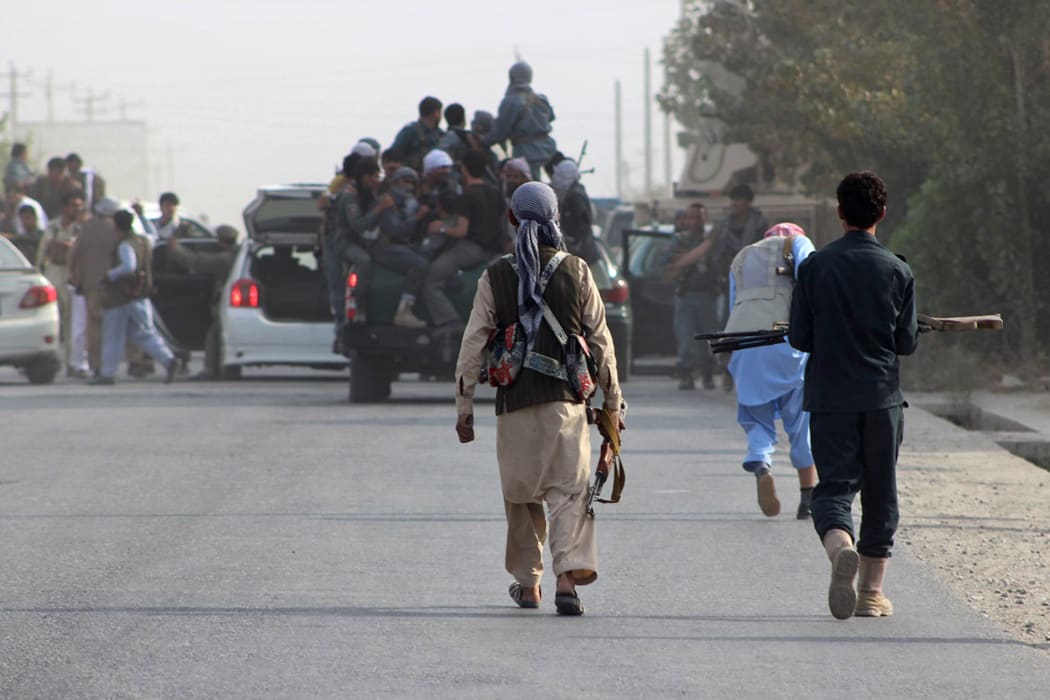 Afghan troops gather in the streets of Kunduz after the city was seized by the Taliban.