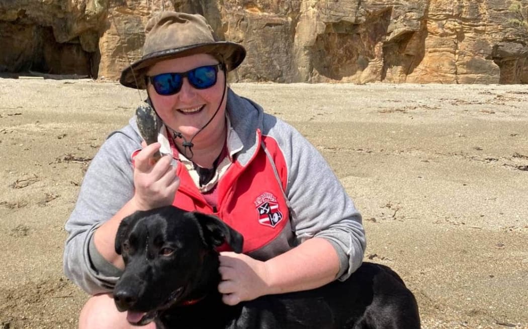 Tokanui resident Kelsi Hayes with her dog Quasi after discovering the shark tag on Thursday evening.