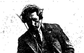 A newspaper photo of Auckland Inventor Victor Penny wearing headphones, 19 March 1936