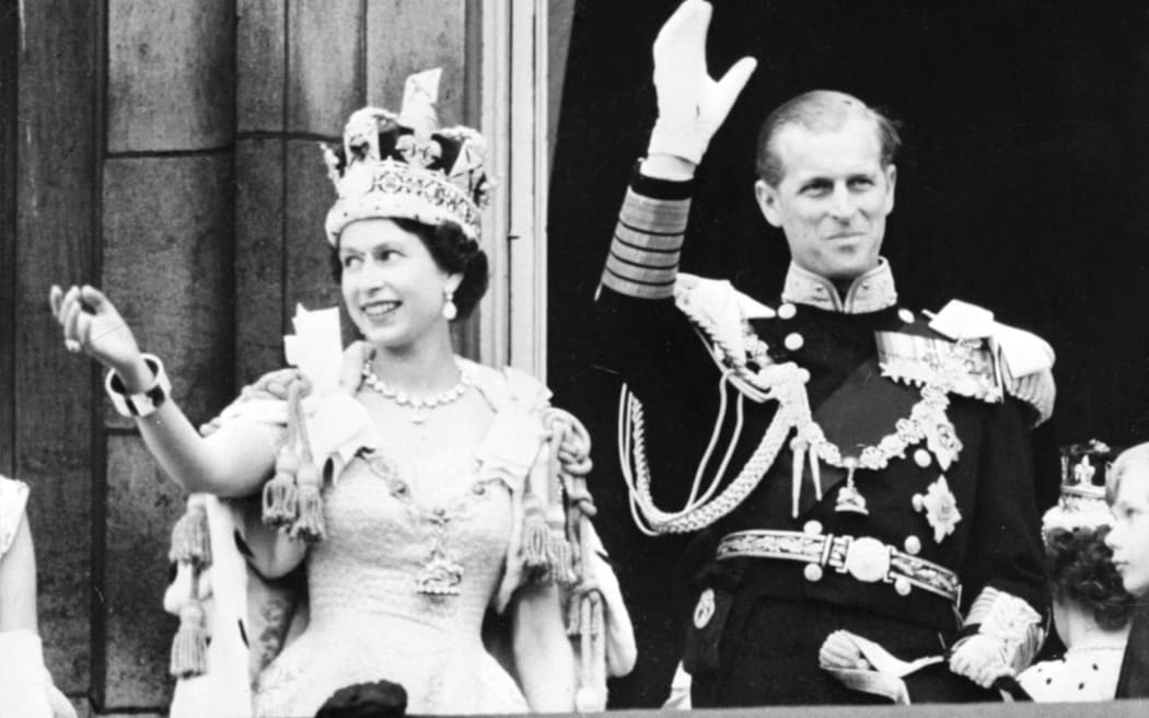 Queen Elizabeth II (L) accompanied by Britain's Prince Philip, Duke of Edinburgh (R) waves to the crowd, June 2, 1953 after being crowned at Westminter Abbey in London.