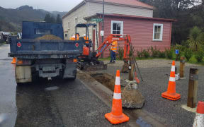 The scene outside Reefton's band hall today as Detection Services and council staff test a leaky pipe.