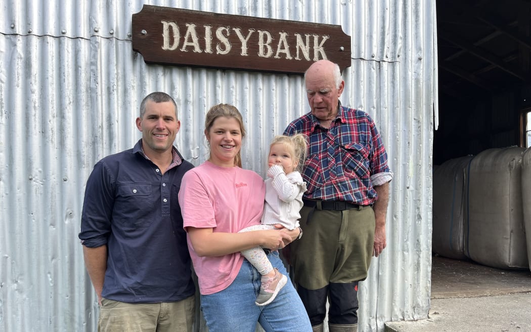 Owen and Emma Harvey, with daughter McKenzie, stand alongside John Harvey, in front of the old woolshed at Daisybank Farm.