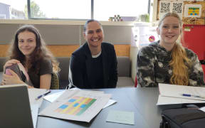 Karanga Mai Young Parents’ College director Whitney Misiuata (centre) checks up on Danielle Black (18, left) and Charlize Geary-Smart (18), who are working on their literacy credits.