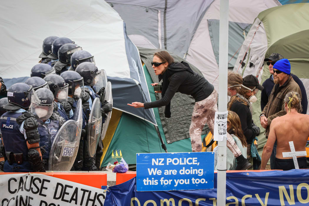 At the Parliament barrier protestors grab a last chance for live streaming some invective as police quietly hold the line