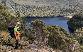 Tokoeka Kiwi researcher Tim Raemaekers, above Shy Lake, Fiordland National Park