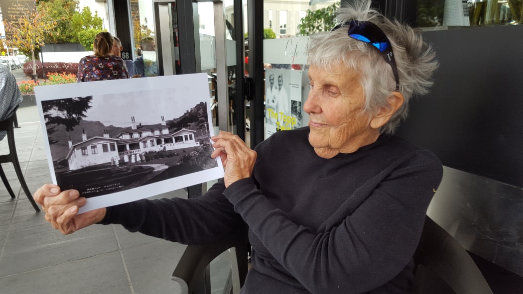 Akaroa resident Gloria Calcutt with  a photo of the former Akaroa Hospital, which she worked at as a nurse from 1977 to 2010.