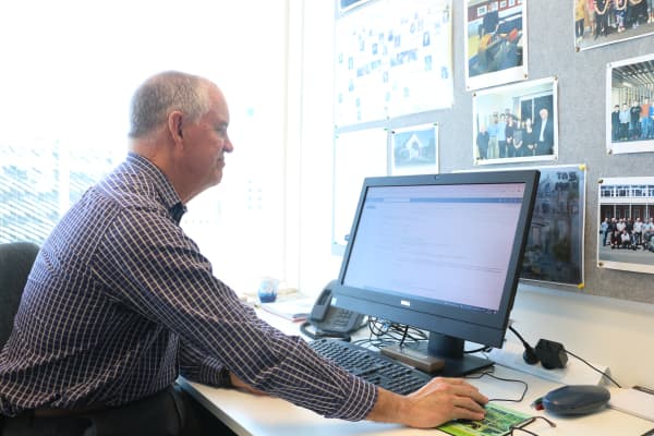 University of Auckland professor of chemistry sciences Paul Kilmartin uses his desktop computer to check his emails.
