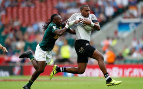 Fiji's Paula Dranisinukula drives through the tackle from South Africa's Seabelo Senatla during the London 7s final.
