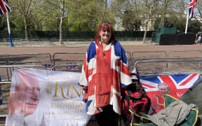 Faith Nicholson, wearing a Union Jack poncho. She came well prepared with banners and bunting - less so with creature comforts.