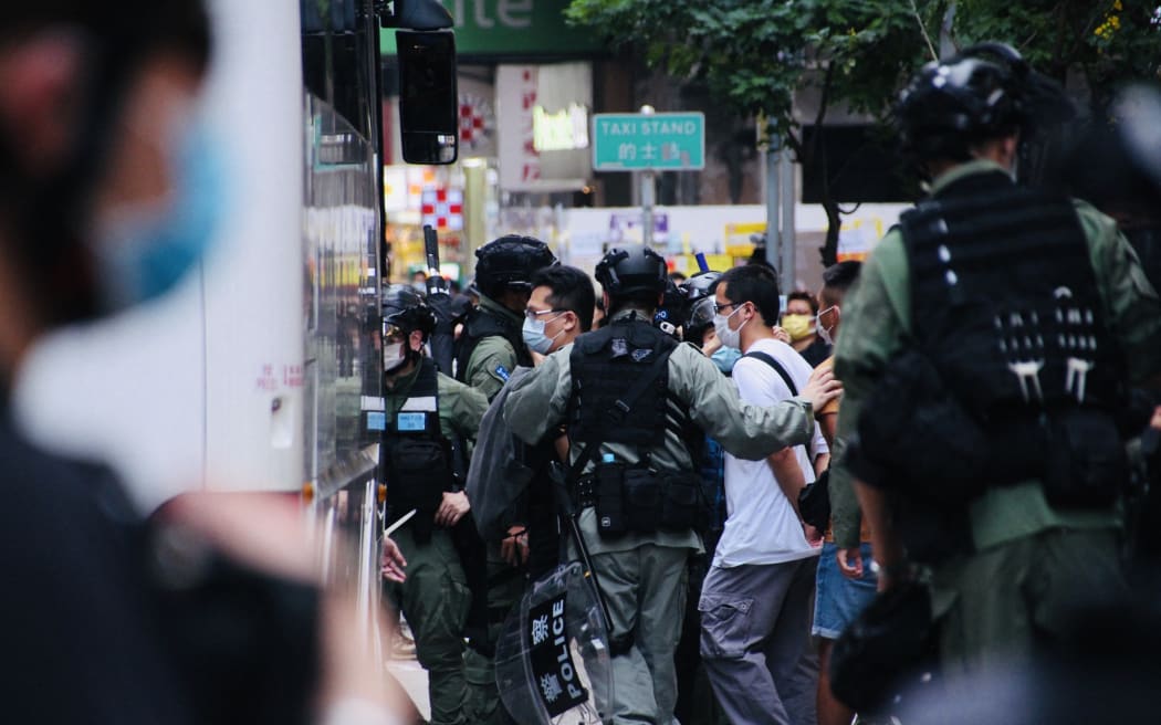 Protesters are arrested and escorted to police station via bus during street demonstrations in Hong Kong, on 1 October 2020.