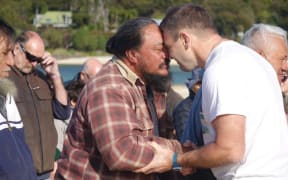 Duane Major and an iwi representive from Te Tau Ihu take part in a hongi on the beach at Awaroa.