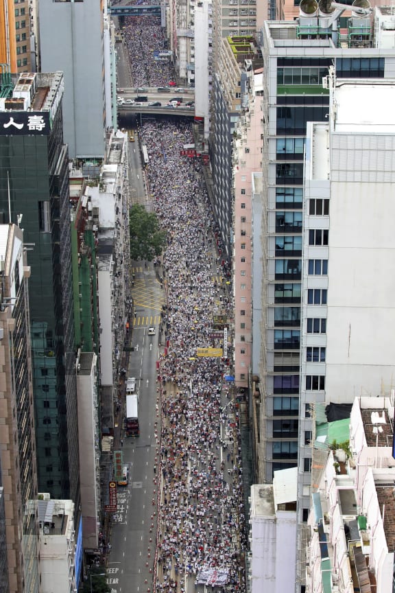 Thousands of protesters march in a rally against the proposed amendments to an extradition law in Hong Kong, Sunday, June 9, 2019.