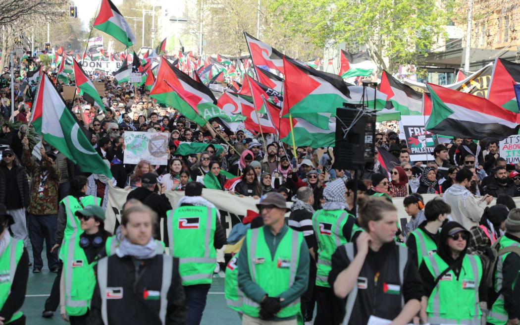 Pro-Palestine demonstrators make their way down Queen Street in Auckland, demanding the government impose sanctions on Israel.