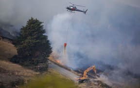 Helicopters and heavy earth-moving equipment are part of the fire response.