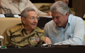 Raul Castro (L) talks with Miguel Diaz-Canel during the First Annual Session of the Cuban Parliament at the Convention Palace in Havana.
