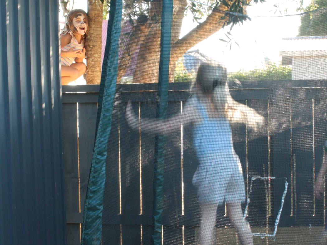 Isabel, 6, and Eve, 5, catch up over the fence