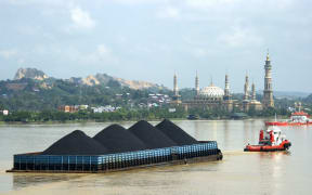 A barge on the river of Mahakam transports coal from the mining area in Samarinda, East Kalimantan in Indonesia.