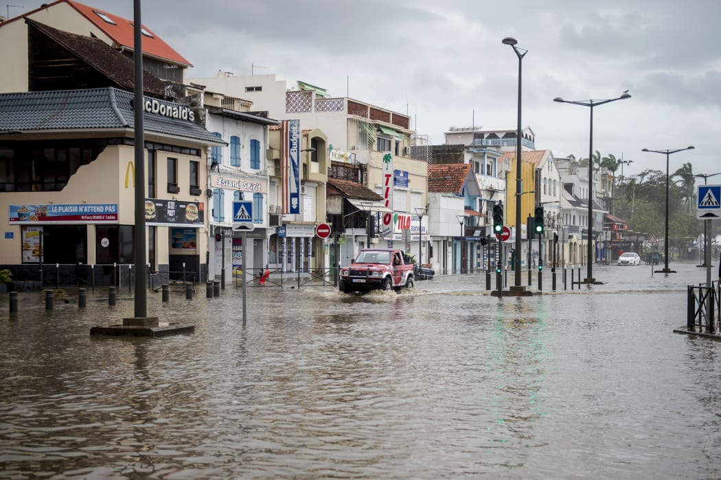 A motorist drives on the flooded waterfront in Fort-de-France, on the French Caribbean island of Martinique, after it was hit by Hurricane Maria, on September 19, 2017