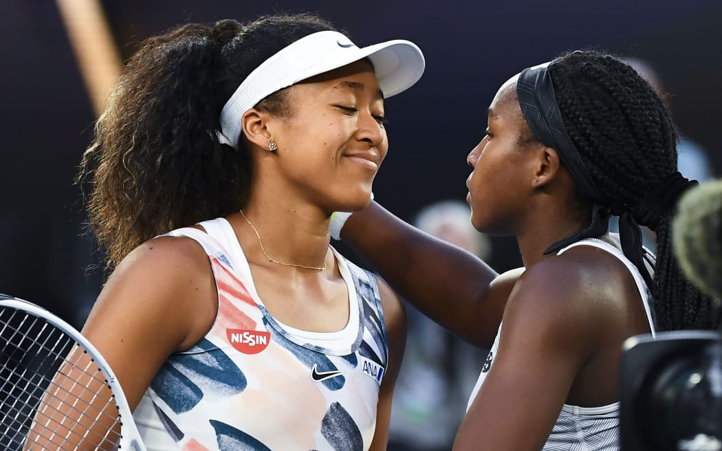 Coco Gauff of the US greets Japan's Naomi Osaka at the end of their women's singles match on day five of the Australian Open tennis tournament in Melbourne on January 24, 2020. (