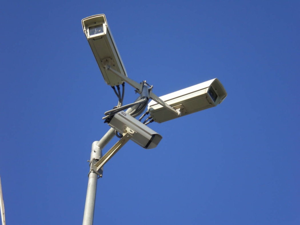 Three video surveillance cameras on a stand