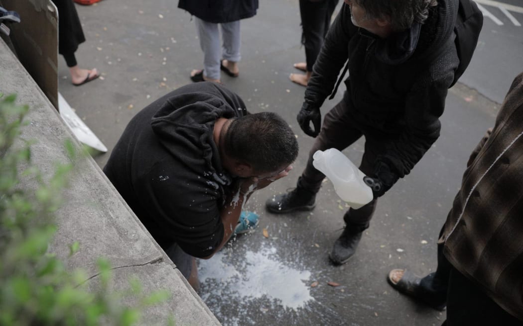 Milk poured over a protester.