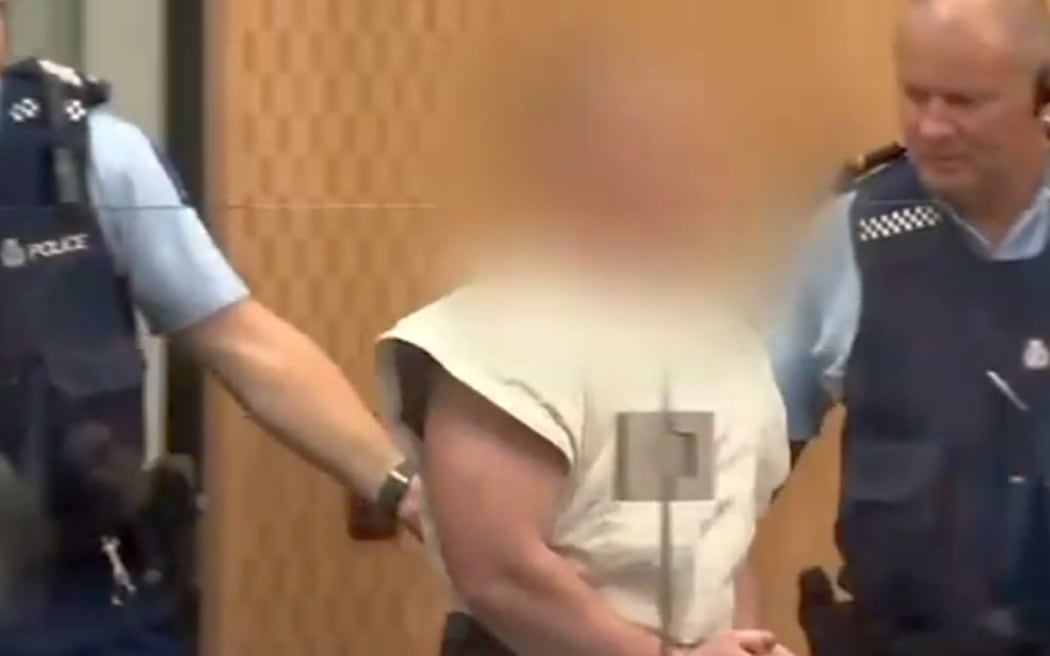 Brenton Tarrant is led into the dock in his first appearance for murder, following the deadly terror attacks on two Christchurch mosques.