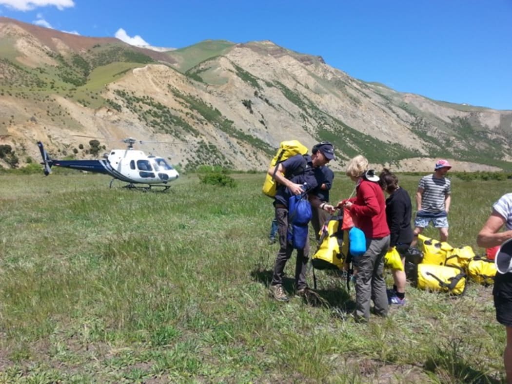 The Clarence rafters were evacuated by helicopter from Muzzle Station. Toby Reid assists Group Leader, Janet Wood