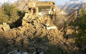 Afghan residents examine a damaged house in Raman Kheel in the Panjshir Valley after the deadly 7.5 magnitude earthquake on 26 October 2015.