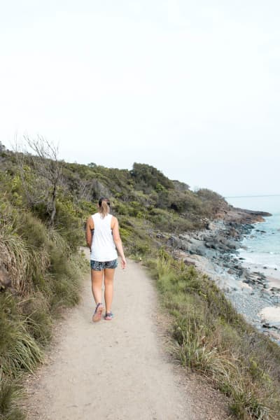 A person walking along a coastal track
