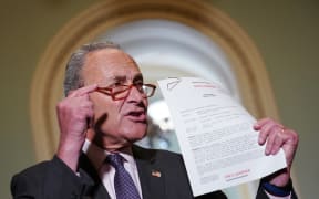 Senate Minority Leader Chuck Schumer (D-NY) speaks to reporters as he holds a transcript of the phone call between US President Donald Trump and Ukraine President Volodymyr Zelensky.