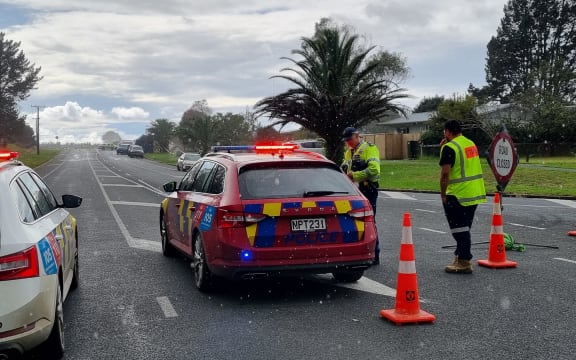 Police block the road following a double homicide in Ruakākā.