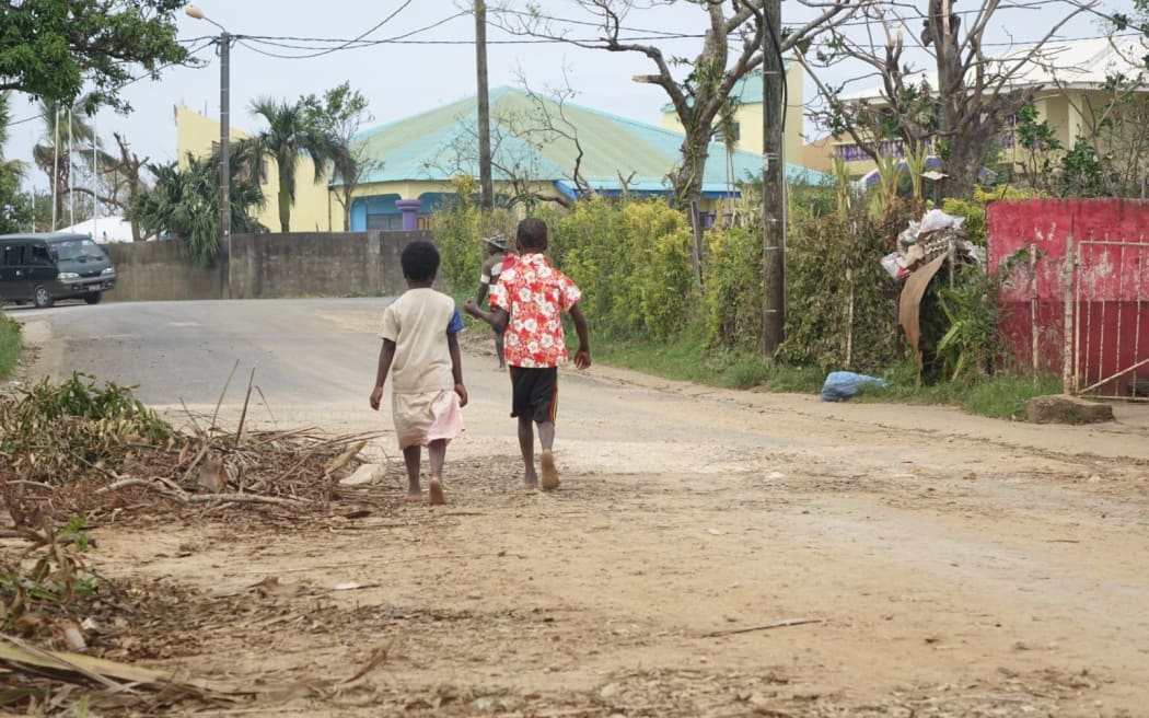 Children walking down a street after vaccination teams visit the area.