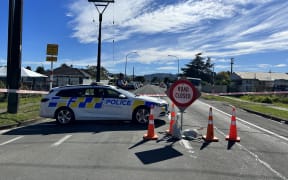 Police at a roadblock near the scene of a brawl in Gisborne in which two people died.