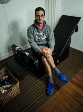 Tickled co-director David Farrier sitting on a purpose-built tickle chair