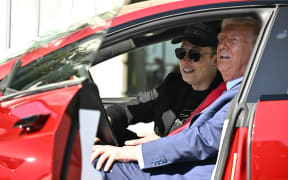 US President Donald Trump and Tesla CEO Elon Musk speak to the press as they sit in a Tesla vehicle on the South Portico of the White House on March 11, 2025 in Washington, DC. (Photo by Mandel NGAN / AFP)