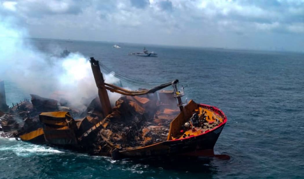 Smoke rises from a fire on board the Singapore-registered X-Press Pearl as it sinks while being towed into deep sea off Colombo Harbour, Sri Lanka, 2 June 2021.