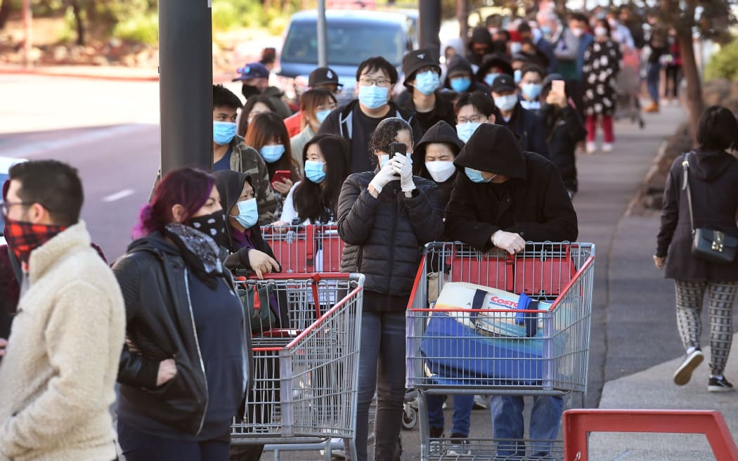Shoppers wait in a long queue outside a Costco outlet in Melbourne on August 2, 2020 as people queue for provision with the Victorian state government expected to annouce harsh new restrictions due to the city battling fresh outbreaks of the COVID-19 coronavirus.