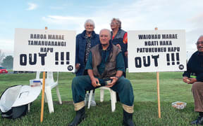 Tūhoe elders (L-R) Te Waiarani Harawira, Paki Nikora and Heni Davis-Teepa are flanked by the names of marae and hapū which have pulled out of Tūhoe governing body Te Uru Taumatua. They said these hapū and marae are now no longer able to access resources and have no voting rights.