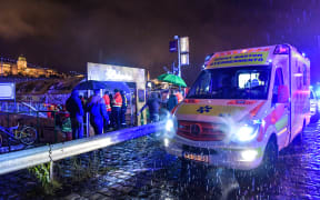 Hundreds of rescue workers try to help at the bank of Danube River after a boat capsized.