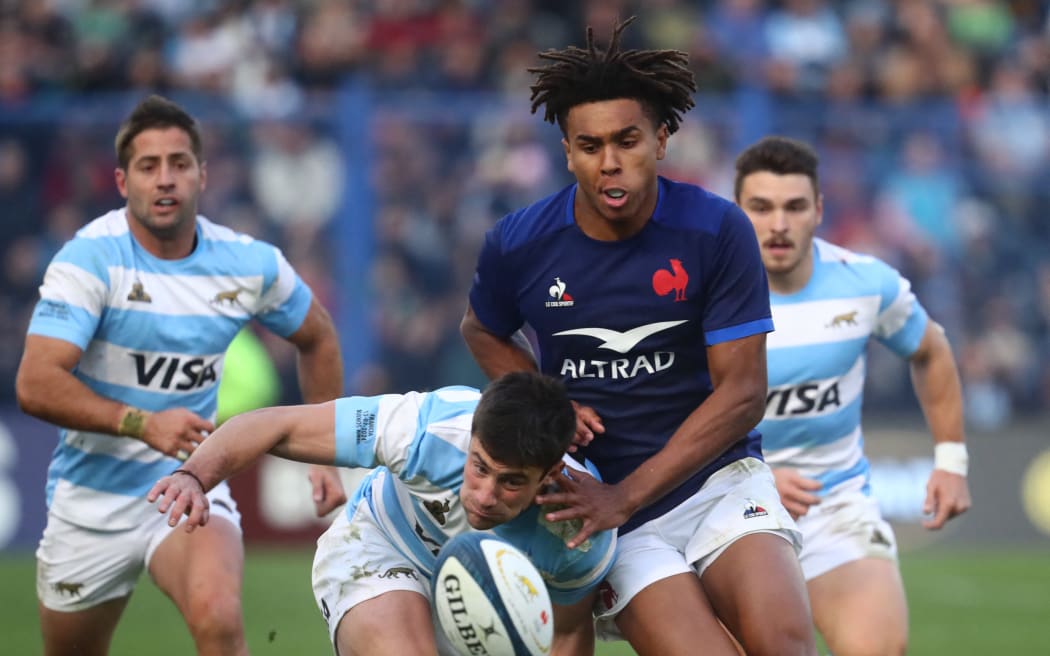 Argentina's wing Bautista Delguy (L) and France's fullback Theo Attissogbe run for the ball during the Test in Buenos Aires.