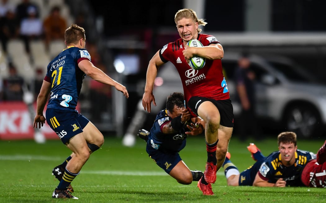 Jack Goodhue of the Crusaders eludes Ash Dixon of the Highlanders during the Super Rugby match, Crusaders v Highlanders at Orangetheory Stadium, Christchurch, New Zealand, 21st February 2020.Copyright photo: John Davidson / www.photosport.nz