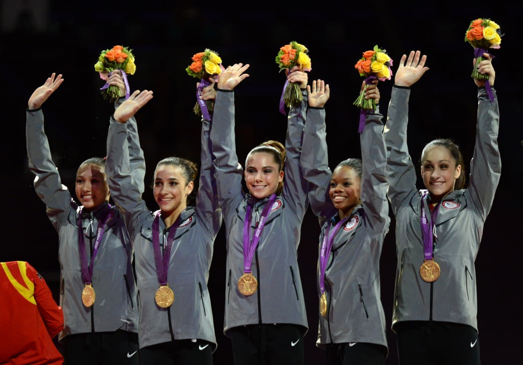 (From L) Gold medalist Team US Kyla Ross, Alexandra Raisman, Mckayla Maroney, Gabrielle Douglas and Jordyn Wieber celebrate on the podium of the women's team competition of the artistic gymnastics event of the London Olympic Games on July 31, 2012 at the 02 North Greenwich Arena in London.