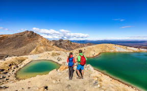 New Zealand tourist hike in Tongariro Alpine Crossing National Park.
