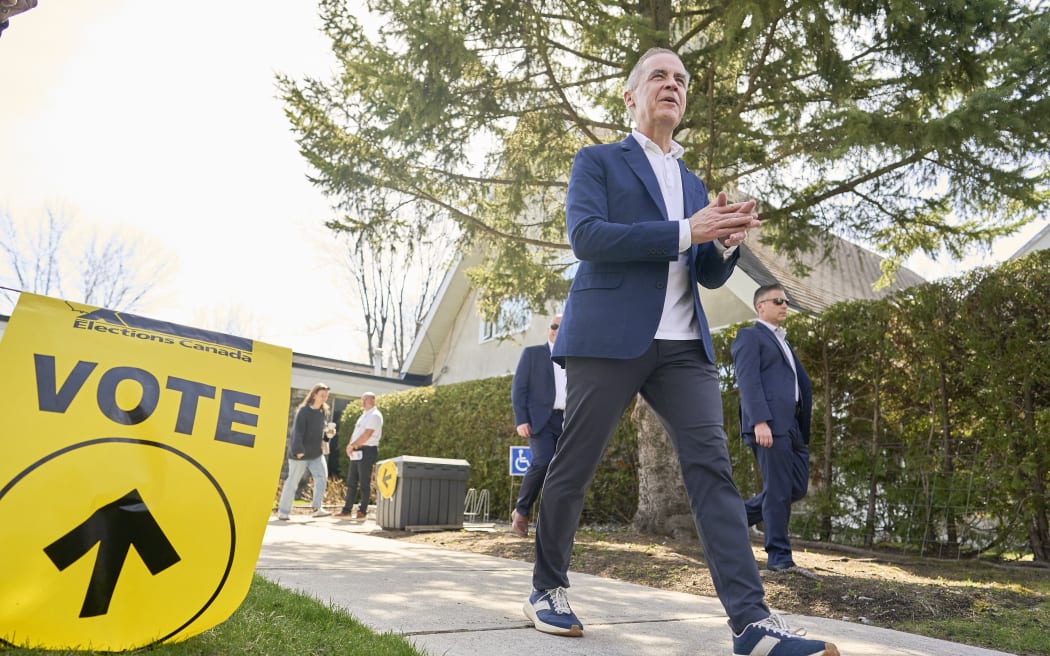 Canadian Prime Minister and Liberal leader Mark Carney leaves a polling station after casting his ballot in the federal election in Ottawa.